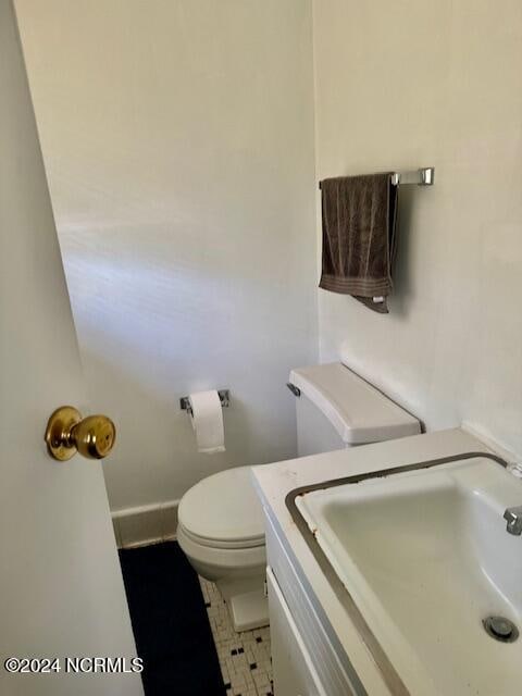 bathroom with vanity, toilet, and tile patterned floors