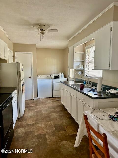 kitchen with black electric range oven, washer and clothes dryer, sink, white cabinets, and ceiling fan