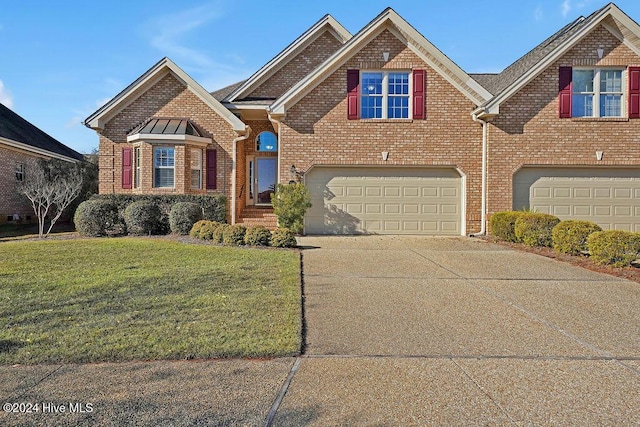 view of front facade with a garage and a front lawn