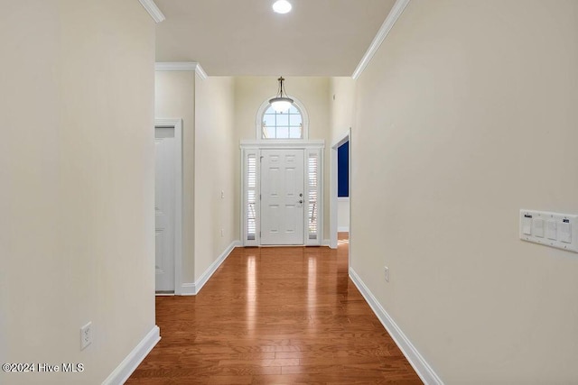 entryway with hardwood / wood-style flooring and ornamental molding