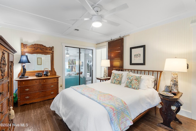 bedroom featuring coffered ceiling, a barn door, ceiling fan, and dark hardwood / wood-style flooring