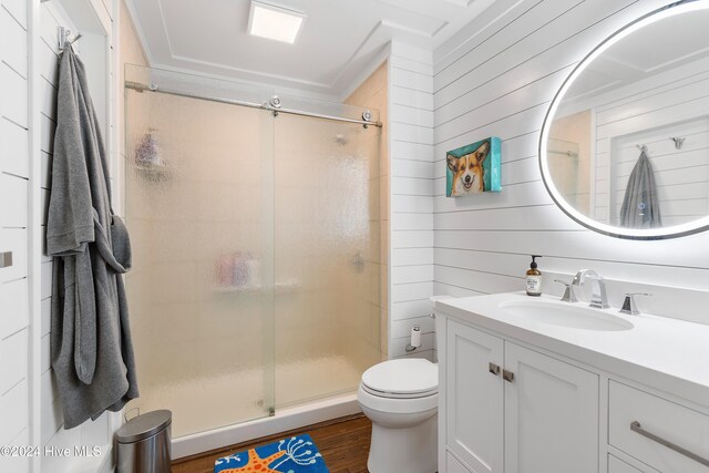 laundry area featuring washer and dryer, hardwood / wood-style flooring, and cabinets