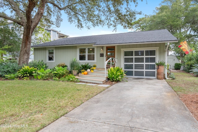 ranch-style home with a front yard and a garage