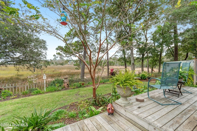 wooden deck featuring a yard