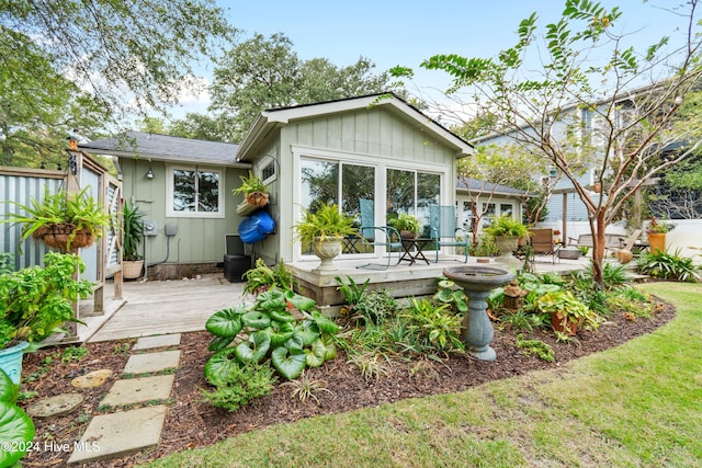 back of house featuring a wooden deck