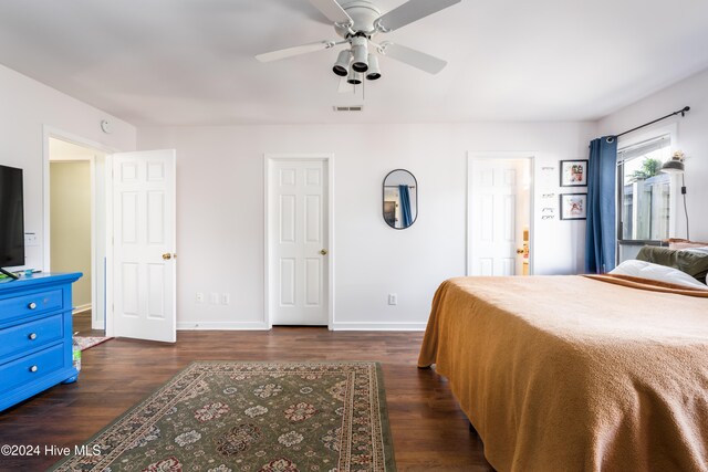 bedroom featuring ceiling fan and dark wood-type flooring