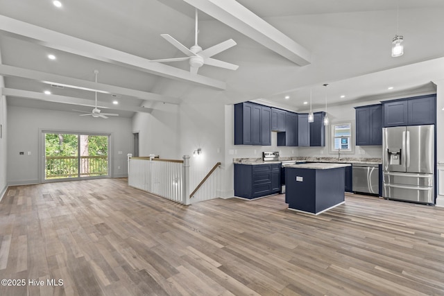 1552 Windsong Dr SW, Ocean Isle Beach, NC 28469 - kitchen featuring stainless steel appliances, a ceiling fan, open floor plan, blue cabinetry, and light wood-style floors