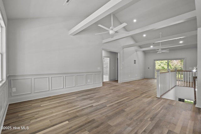 1552 Windsong Dr SW, Ocean Isle Beach, NC 28469 - unfurnished room featuring a ceiling fan, beam ceiling, wood finished floors, recessed lighting, and a wainscoted wall