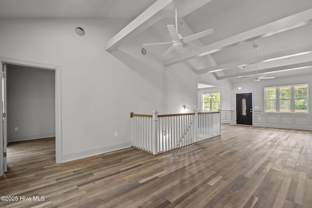 1552 Windsong Dr SW, Ocean Isle Beach, NC 28469 - empty room featuring a ceiling fan, high vaulted ceiling, wood finished floors, and beam ceiling