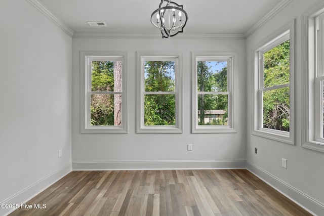1552 Windsong Dr SW, Ocean Isle Beach, NC 28469 - spare room featuring a chandelier, wood finished floors, baseboards, and crown molding