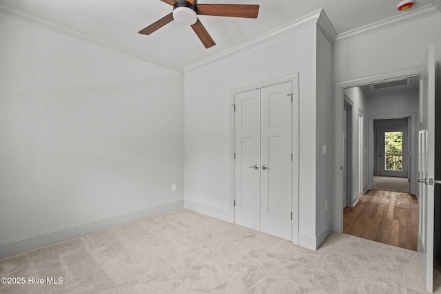 1552 Windsong Dr SW, Ocean Isle Beach, NC 28469 - unfurnished bedroom with crown molding, carpet flooring, baseboards, a closet, and ceiling fan