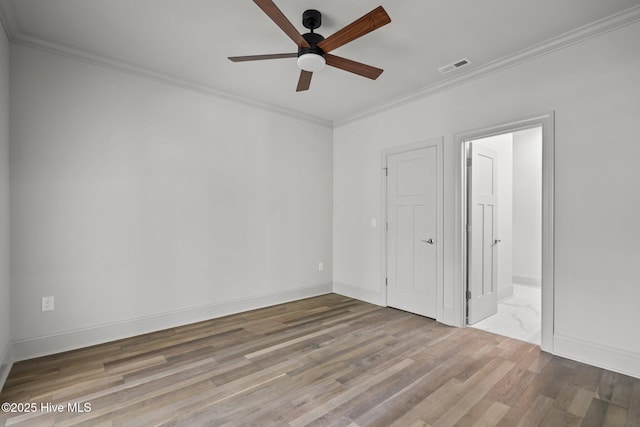 1552 Windsong Dr SW, Ocean Isle Beach, NC 28469 - unfurnished bedroom featuring crown molding, wood finished floors, baseboards, and a ceiling fan