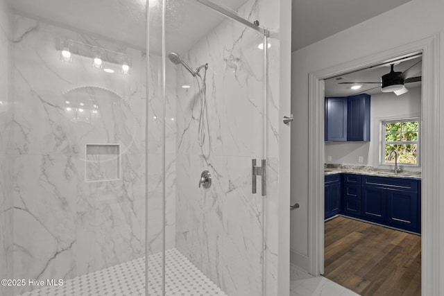 1552 Windsong Dr SW, Ocean Isle Beach, NC 28469 - full bathroom featuring a marble finish shower, vanity, a ceiling fan, and wood finished floors
