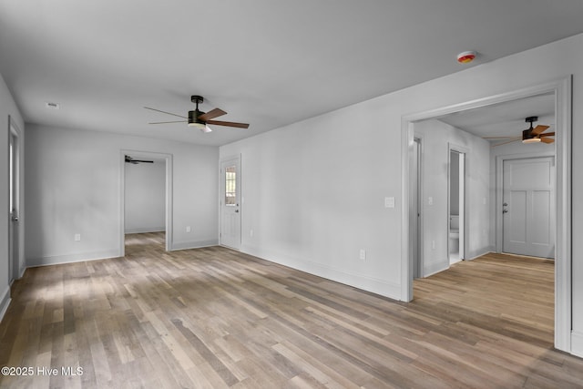 1552 Windsong Dr SW, Ocean Isle Beach, NC 28469 - empty room with a ceiling fan, light wood-style floors, and baseboards
