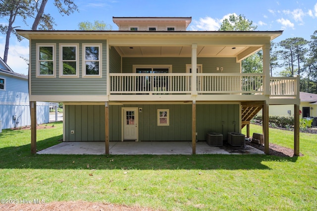 1552 Windsong Dr SW, Ocean Isle Beach, NC 28469 - back of property with a patio area, a yard, board and batten siding, and a wooden deck