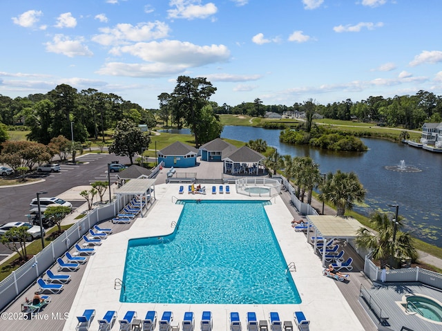 1552 Windsong Dr SW, Ocean Isle Beach, NC 28469 - community pool with a water view, view of scattered trees, and a patio area