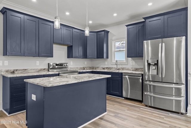 1552 Windsong Dr SW, Ocean Isle Beach, NC 28469 - kitchen featuring appliances with stainless steel finishes, a center island, light wood finished floors, a sink, and light stone counters