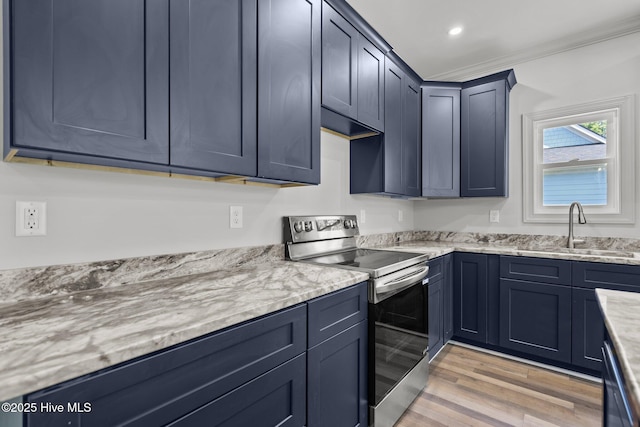 1552 Windsong Dr SW, Ocean Isle Beach, NC 28469 - kitchen with stainless steel electric range, light wood finished floors, a sink, ornamental molding, and light stone countertops