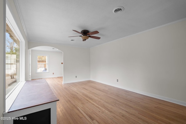 unfurnished living room with light hardwood / wood-style floors, crown molding, and ceiling fan