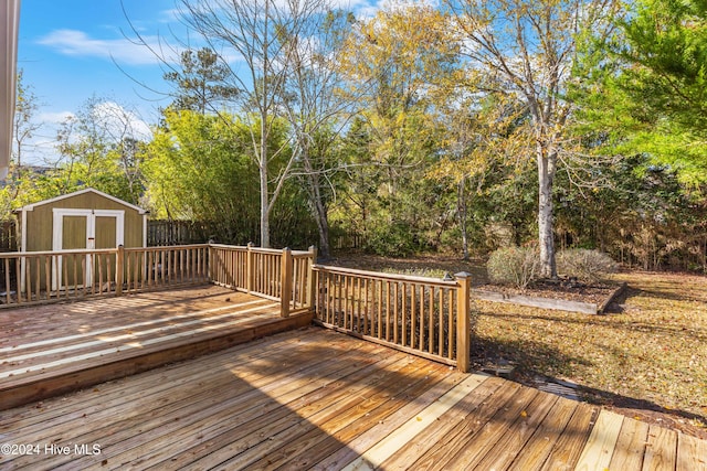 wooden terrace featuring a storage shed