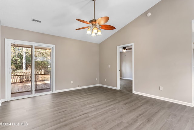 empty room featuring wood-type flooring and high vaulted ceiling