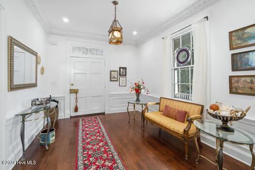 entrance foyer featuring dark hardwood / wood-style flooring and ornamental molding