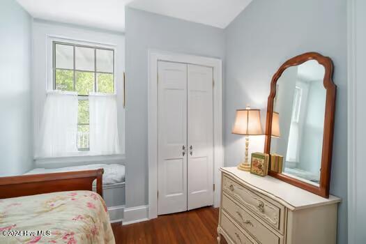 bedroom with a closet and dark hardwood / wood-style flooring