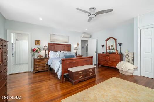 bedroom with ceiling fan and dark hardwood / wood-style floors