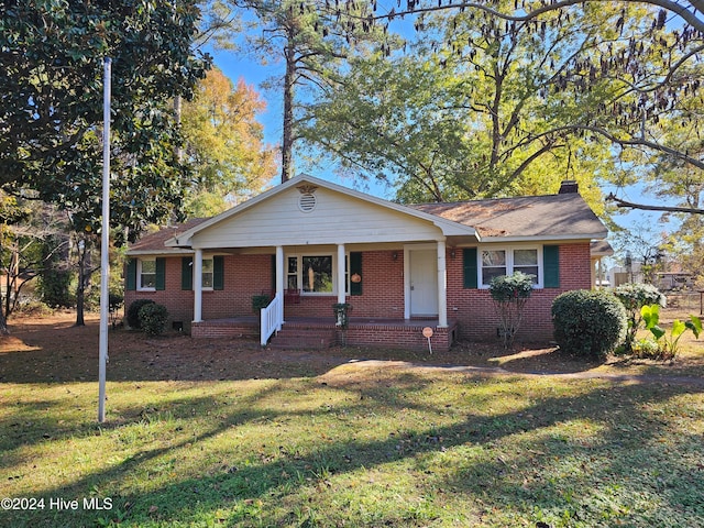 ranch-style house with a front yard and a porch