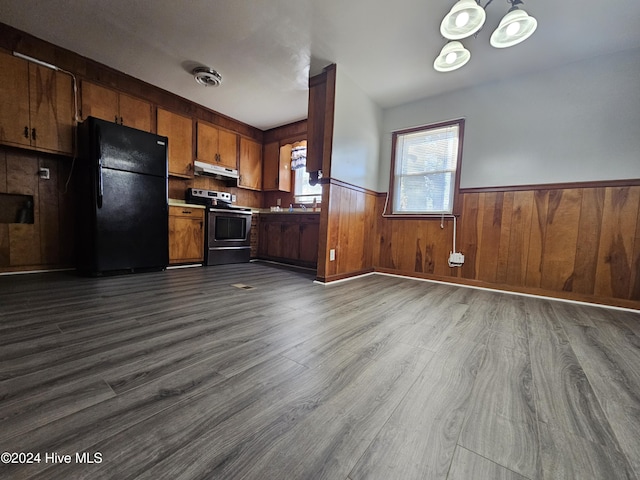 kitchen with stainless steel range with electric stovetop, wood-type flooring, a chandelier, and black fridge