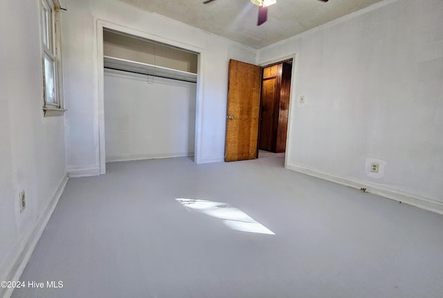 unfurnished bedroom with a closet, concrete floors, and ceiling fan