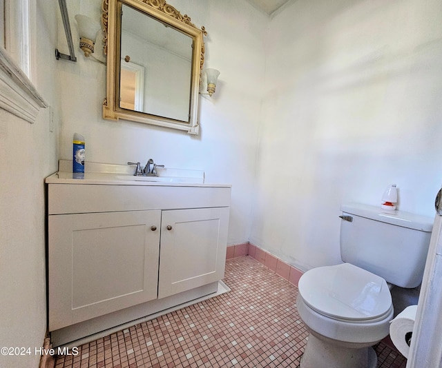 bathroom featuring tile patterned floors, toilet, vanity, and baseboards