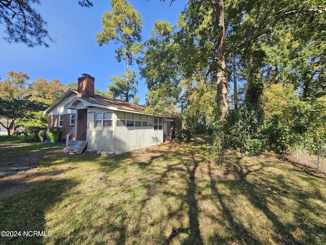 exterior space featuring a yard and a chimney