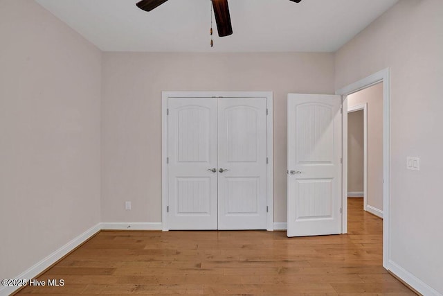 unfurnished bedroom featuring light hardwood / wood-style flooring, a closet, and ceiling fan