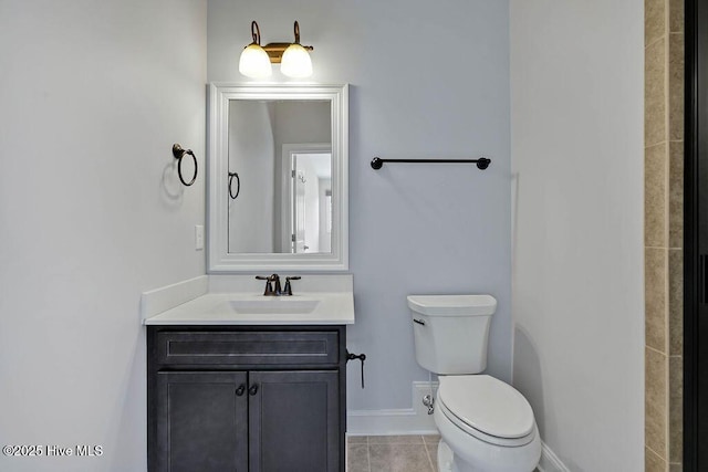 bathroom with tile patterned flooring, vanity, and toilet