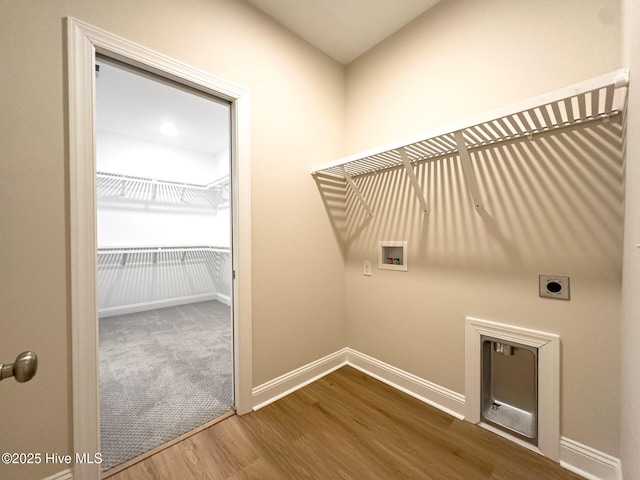 washroom featuring electric dryer hookup, hookup for a washing machine, and hardwood / wood-style flooring