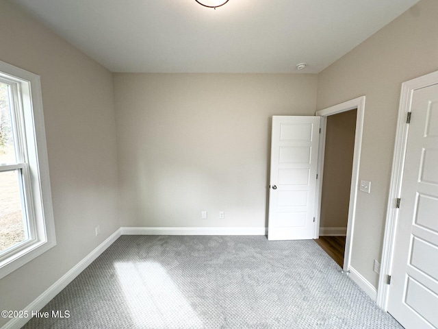 unfurnished room with light carpet and a healthy amount of sunlight