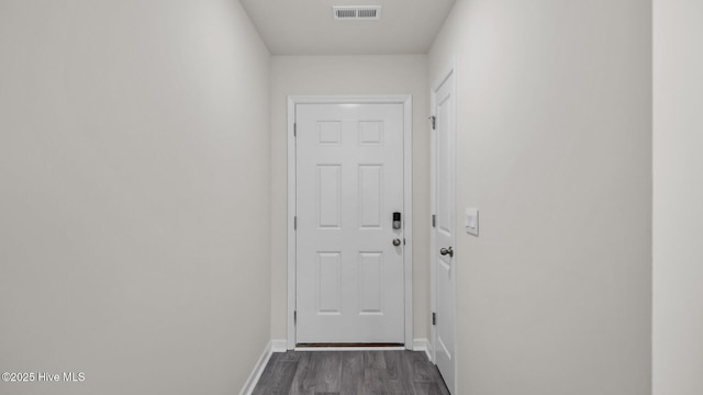 entryway featuring dark wood-style flooring, visible vents, and baseboards