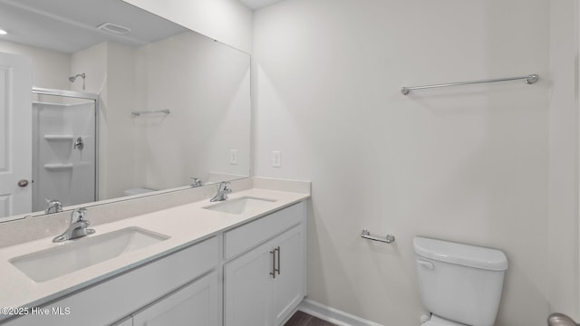 full bath featuring toilet, a shower stall, double vanity, and a sink