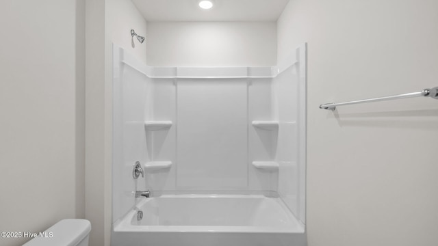 bathroom featuring toilet and bathing tub / shower combination