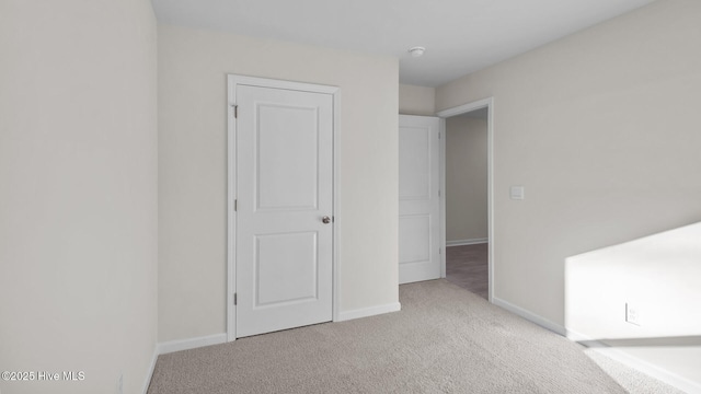 unfurnished bedroom with carpet and baseboards