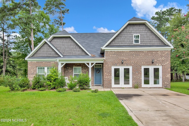 6639 Ramsey St, Fayetteville, NC 28311 - view of front of property featuring french doors, a front lawn, and brick siding
