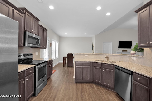 6639 Ramsey St, Fayetteville, NC 28311 - kitchen featuring stainless steel appliances, wood finished floors, dark brown cabinets, tasteful backsplash, and recessed lighting