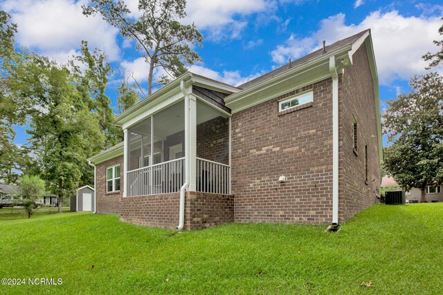 6639 Ramsey St, Fayetteville, NC 28311 - view of home's exterior with brick siding, a sunroom, and a lawn
