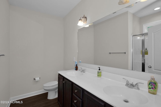 6639 Ramsey St, Fayetteville, NC 28311 - bathroom featuring wood finished floors, double vanity, and a shower stall