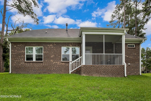 6639 Ramsey St, Fayetteville, NC 28311 - rear view of house featuring brick siding, a yard, and a sunroom