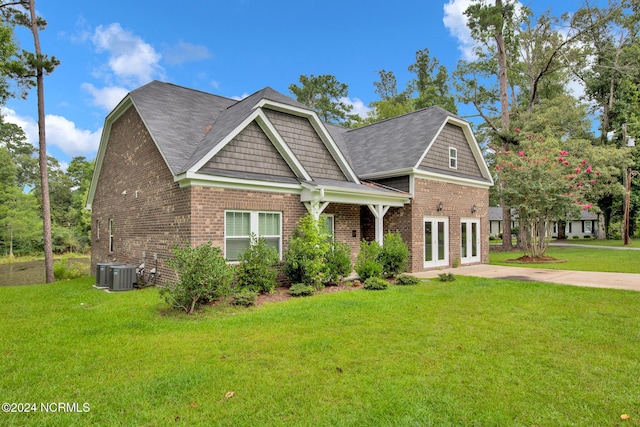 6639 Ramsey St, Fayetteville, NC 28311 - view of front of home featuring a front lawn, brick siding, and french doors