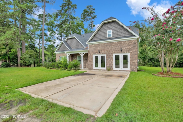 6639 Ramsey St, Fayetteville, NC 28311 - view of front facade with french doors, brick siding, and a front lawn