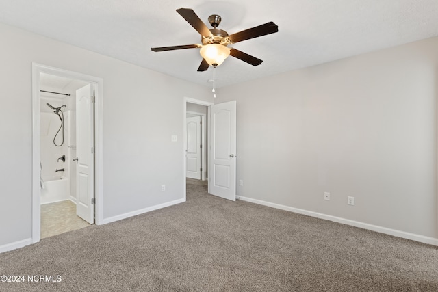 unfurnished bedroom featuring ensuite bathroom, ceiling fan, and light colored carpet