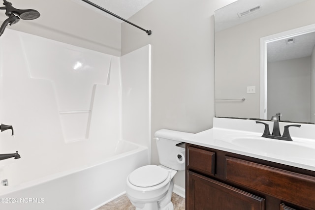 full bathroom featuring a textured ceiling, vanity, toilet, and shower / bathtub combination